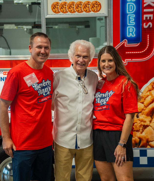  Travelin’ Tom’s Coffee Truck franchise members posing next to Tom Lamb